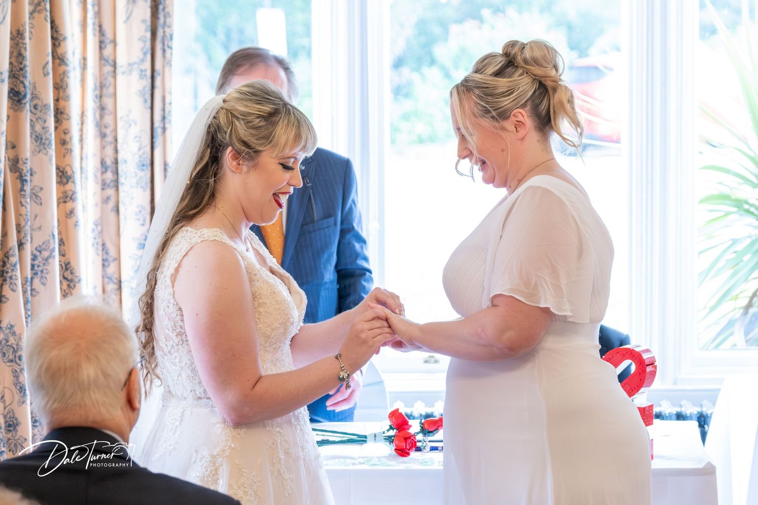 Wedding ceremony moments captured in sequence showing ring exchanges near a window.