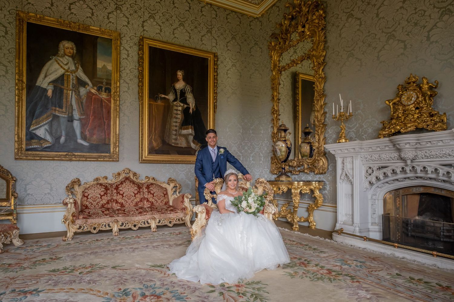 Ornate baroque style room with gilded details and classical paintings.