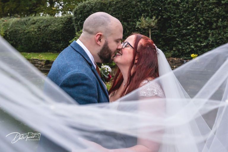 Wedding veil flowing in the wind during an outdoor photo session.