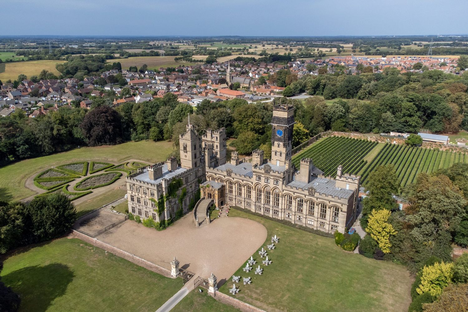 Aerial view of Carlton Towers, a Victorian Gothic country house with manicured gardens in Yorkshire.