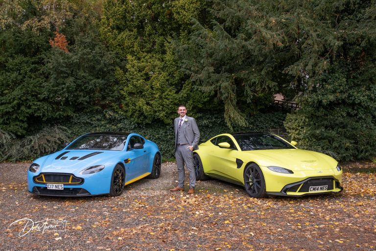 Luxury sports cars in vibrant blue and yellow colors parked among autumn leaves.