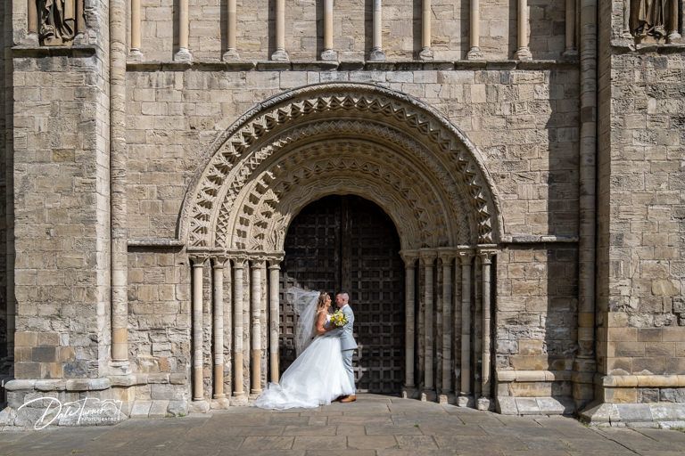 Stone archway entrance of historic Gothic cathedral with ornate architectural details.
