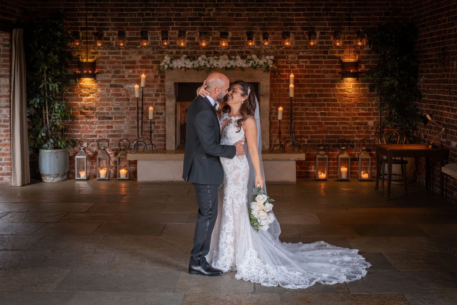 Romantic wedding photos against exposed brick walls with warm lighting and industrial charm.