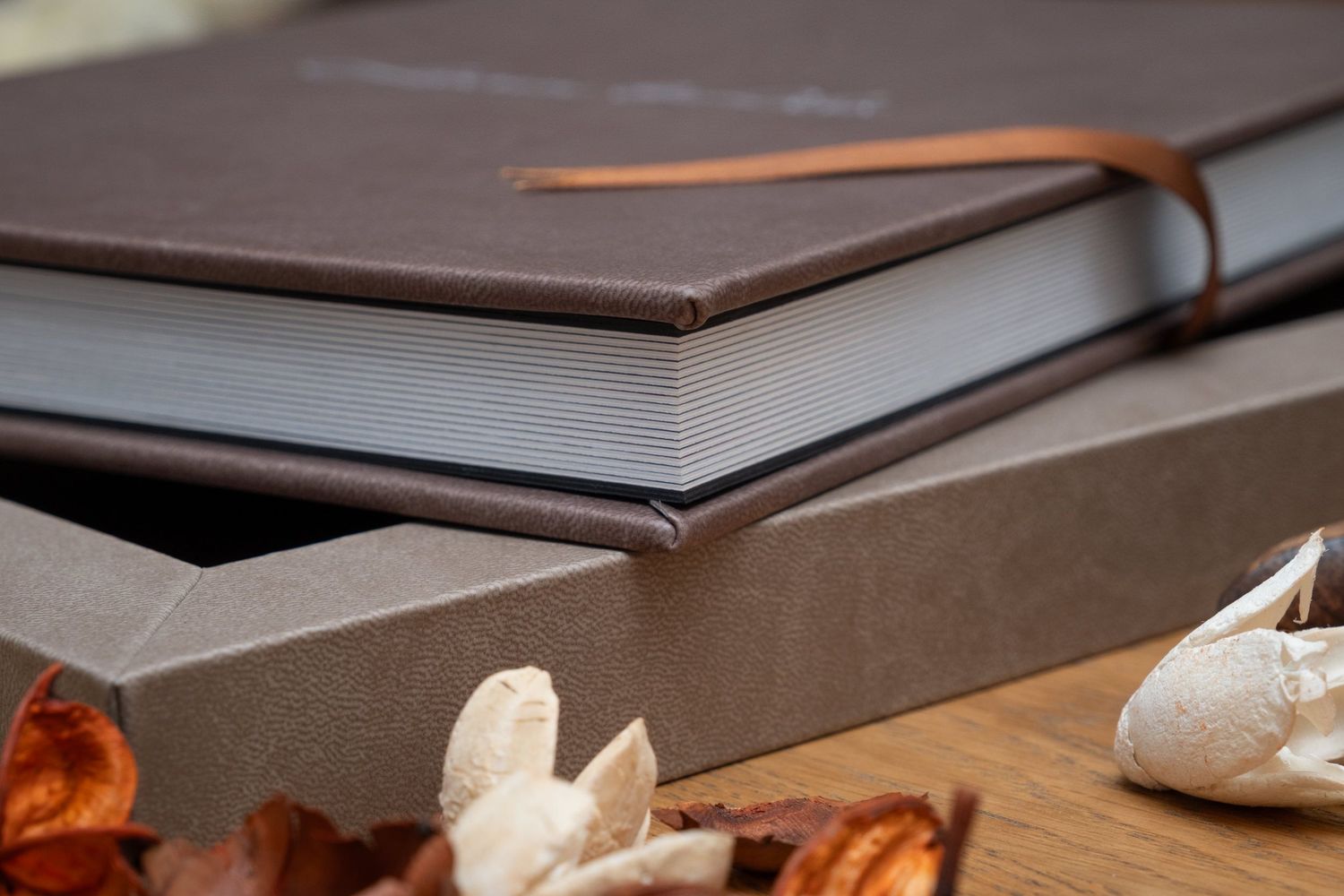 Luxury wedding album with brown leather accents and ribbon details.