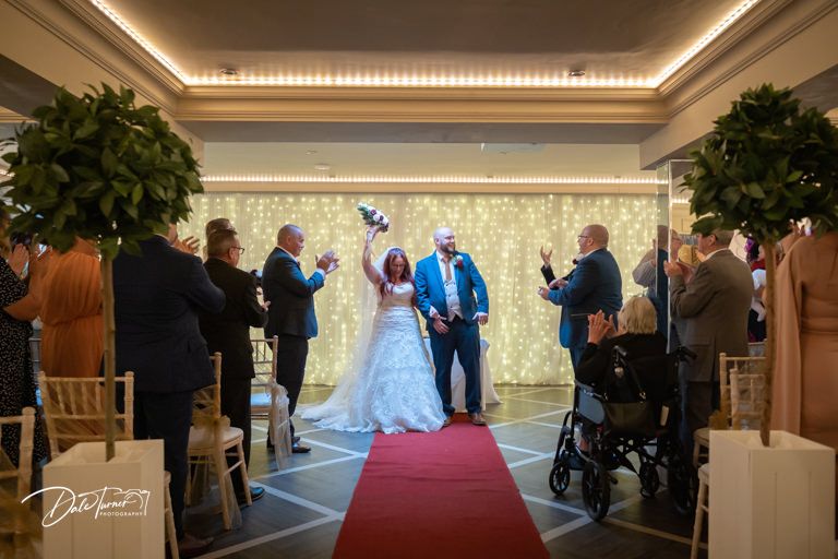 Wedding ceremony venue with elegant lighting and red carpet aisle.