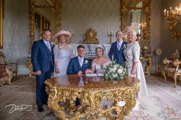Elegant wedding venue with ornate gold mirrors and decorative wall details.