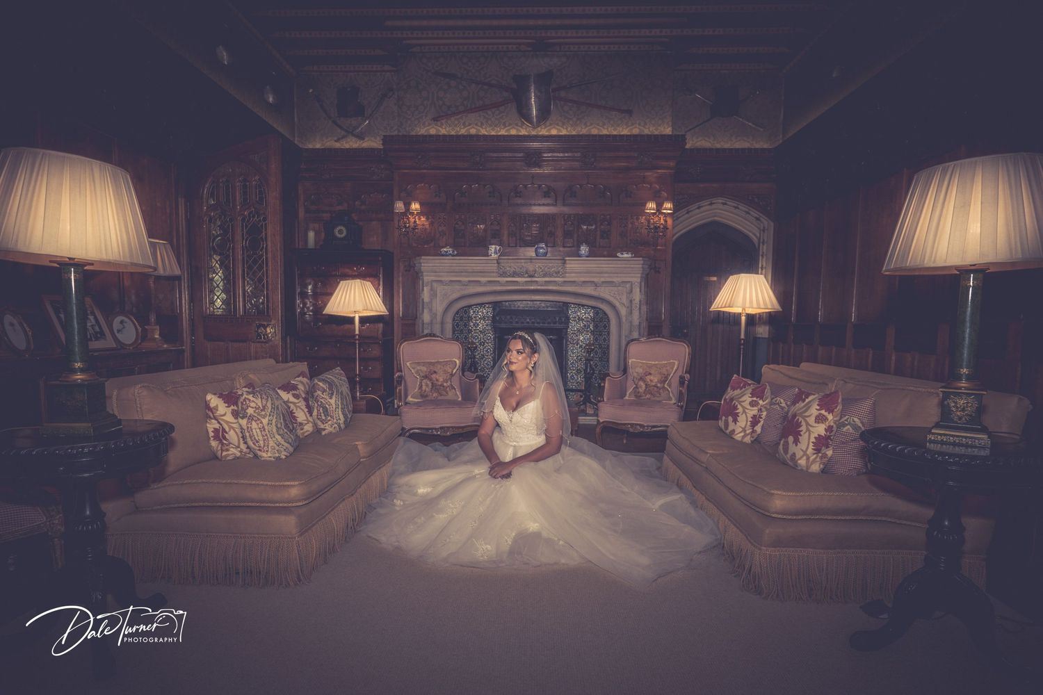A dramatic wide-angle view of an ornate room with chandeliers and elegant lampshades.
