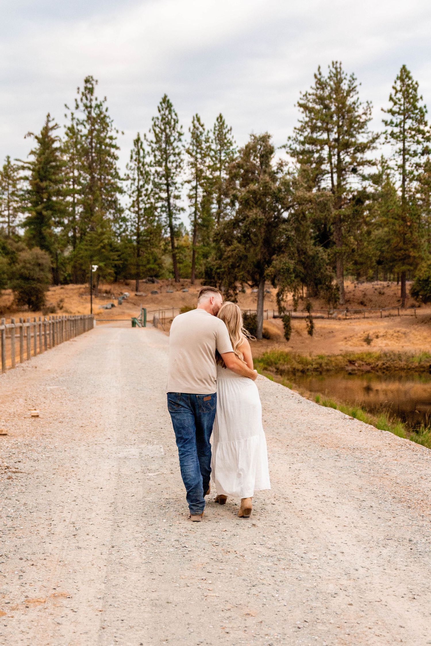 man and woman walking by lake in Pine Grove, California