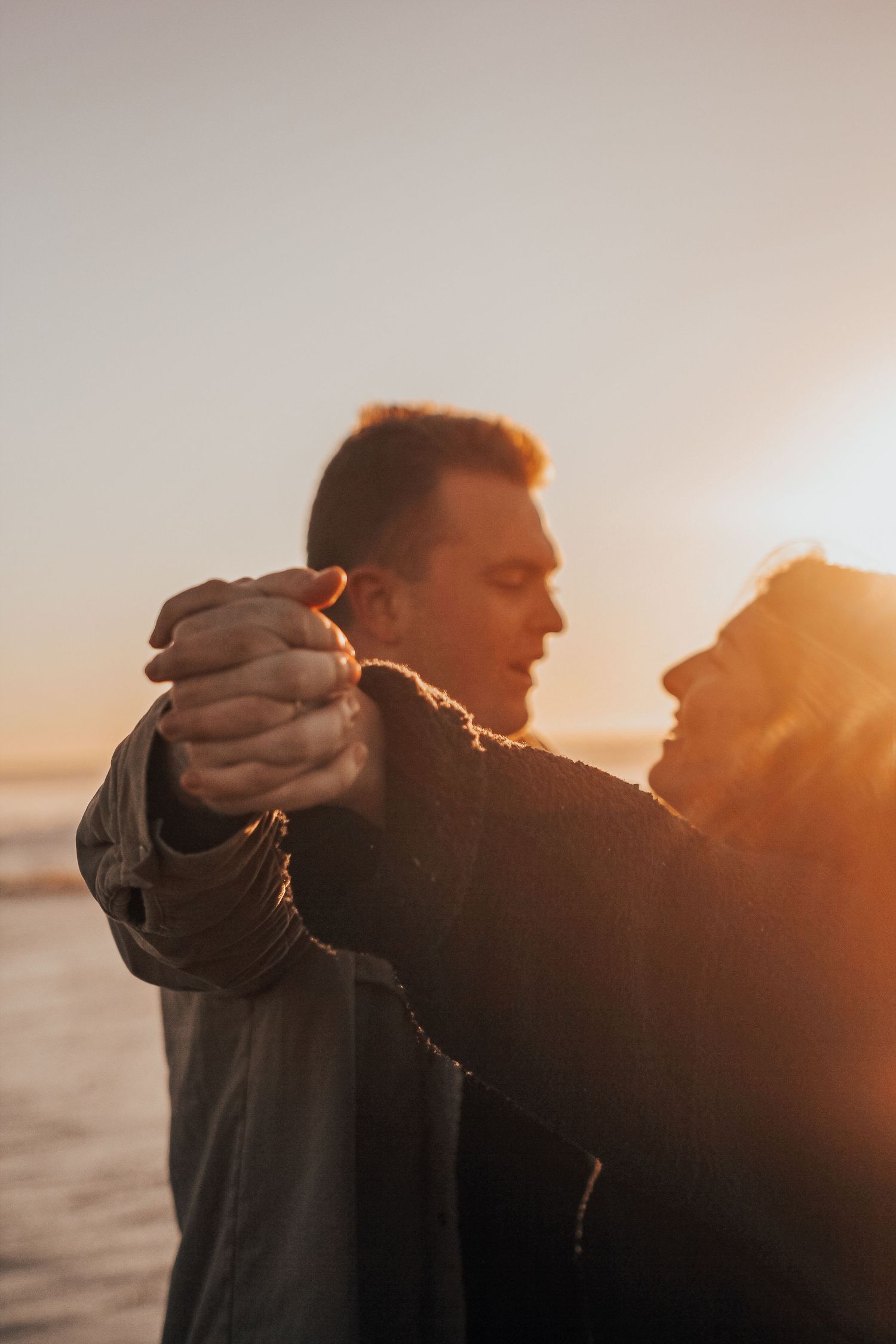 man and woman on beach at sunset in Encinitas, California