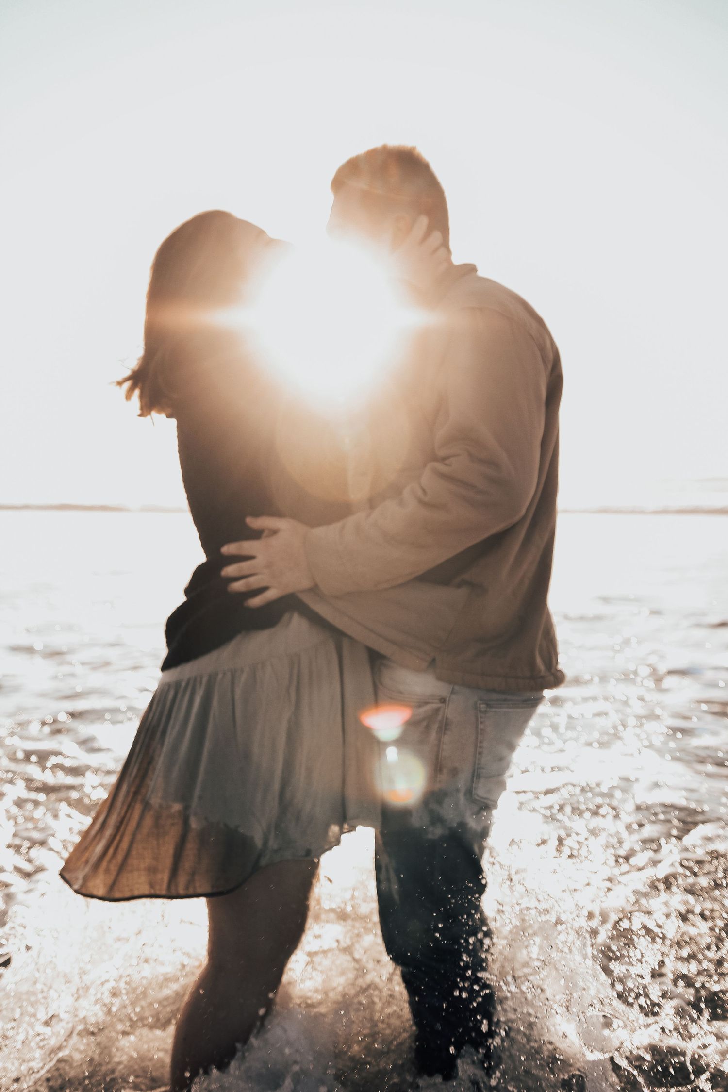 sunset photo of a man and woman in ocean