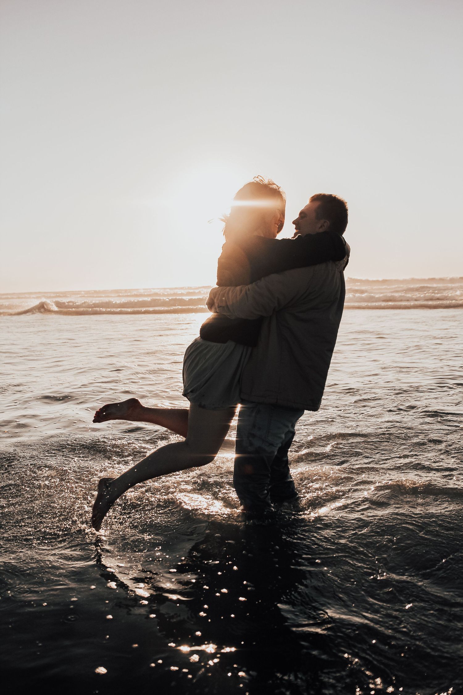 man and woman dance in ocean in Encinitas, California