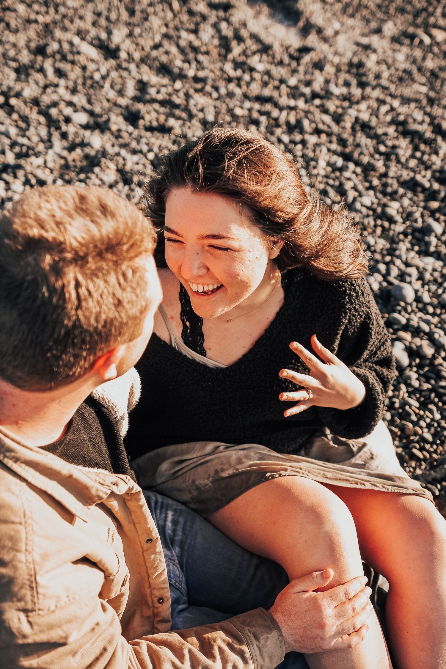 man and woman sitting on beach in Encinitas, California