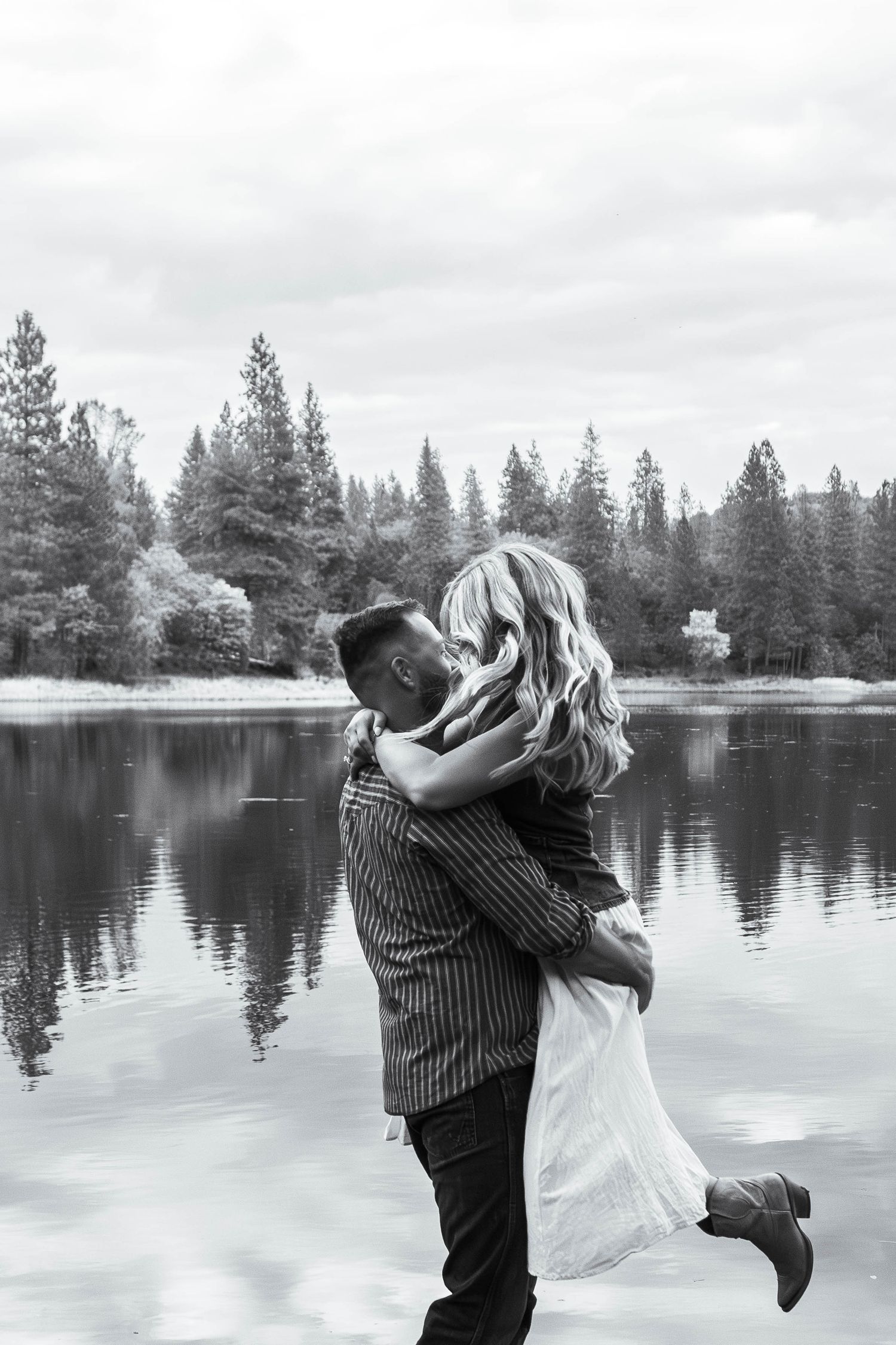 man and woman dancing by lake in Pine Grove, California
