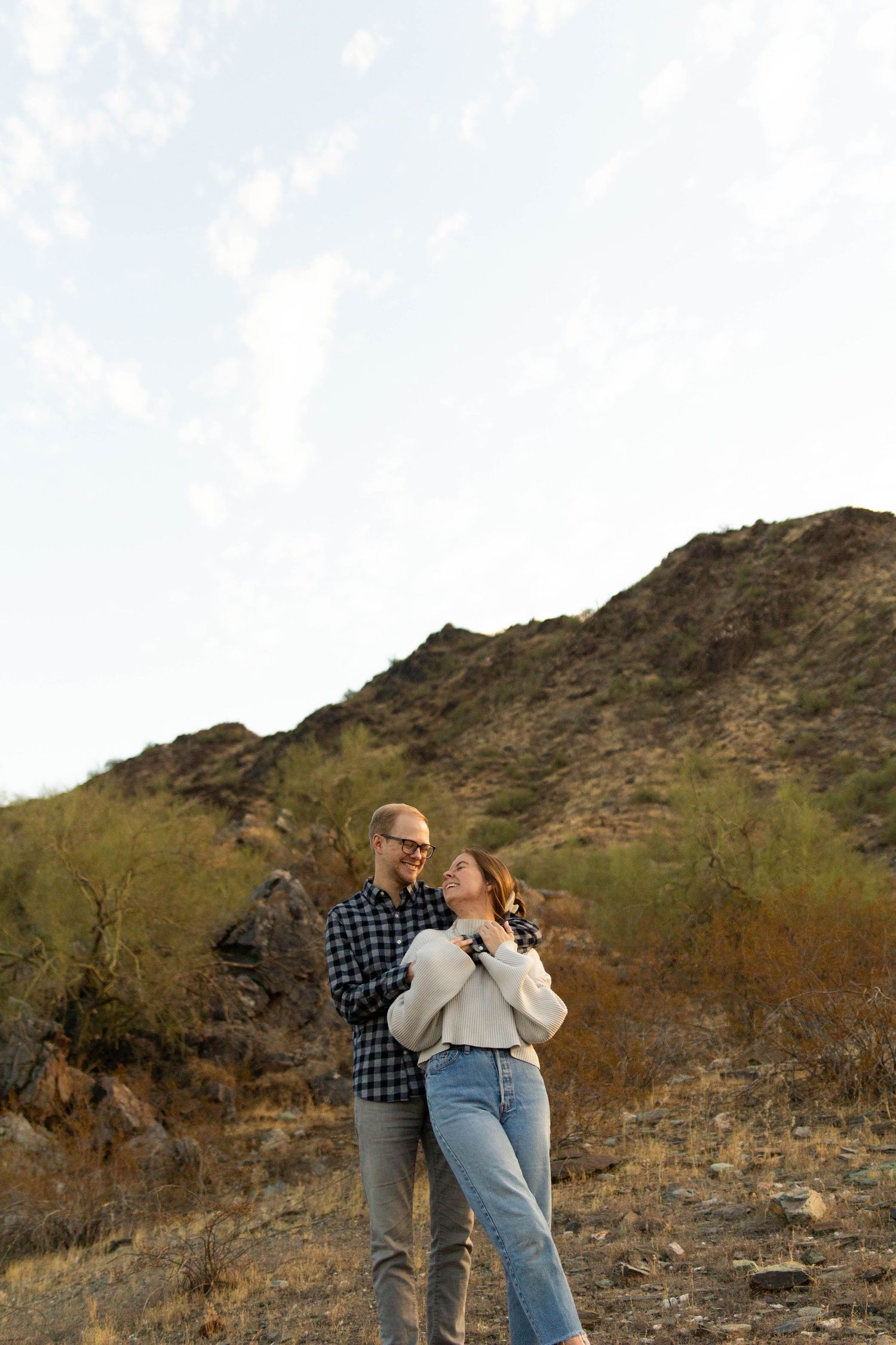 man and woman hug in desert landscape in Arizona