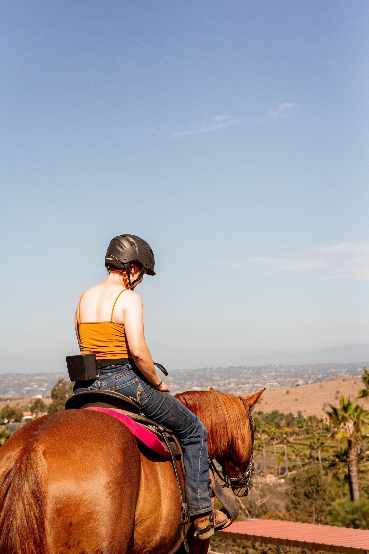 Girl and horse on trail ride in San Diego