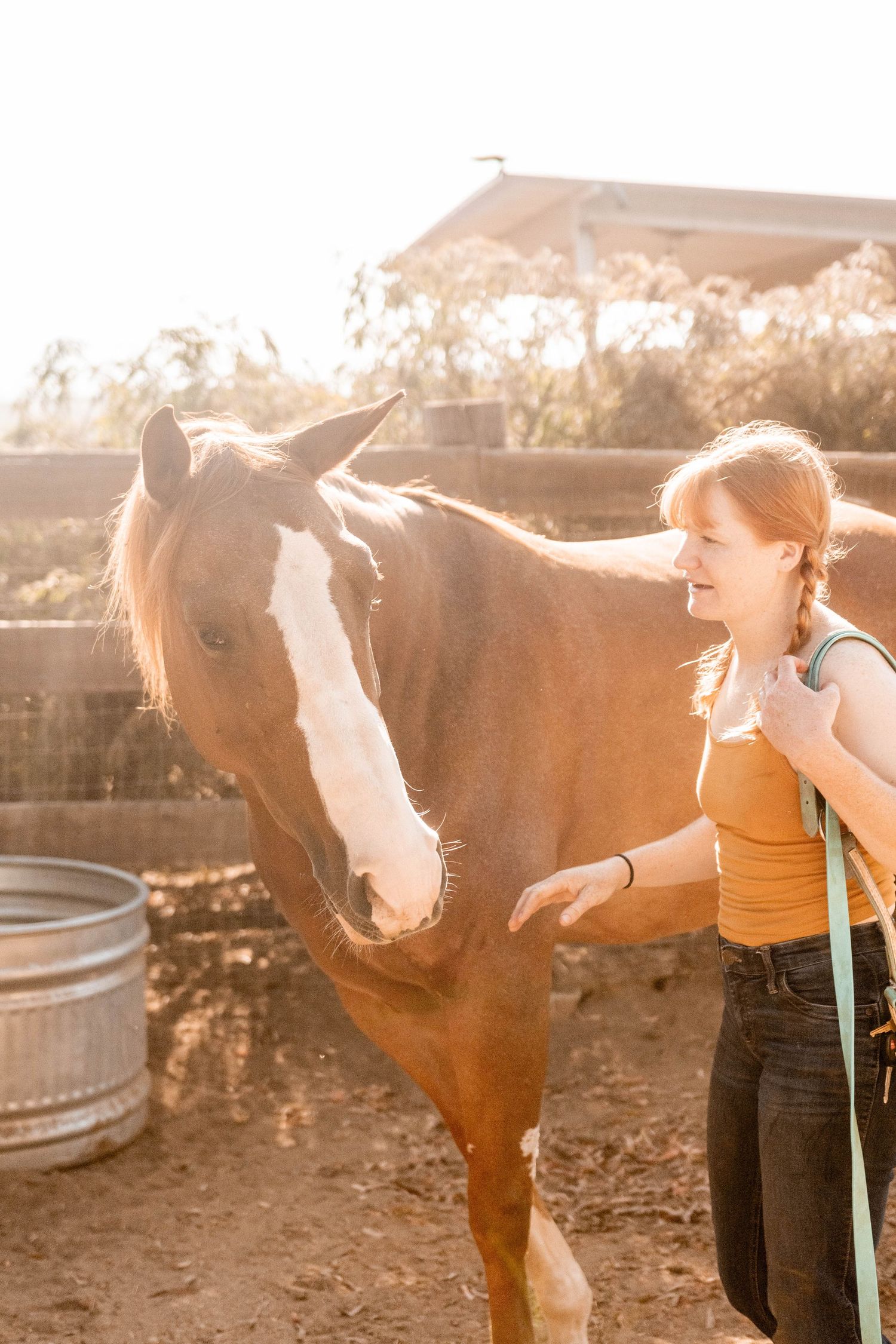girl gets horse from corral