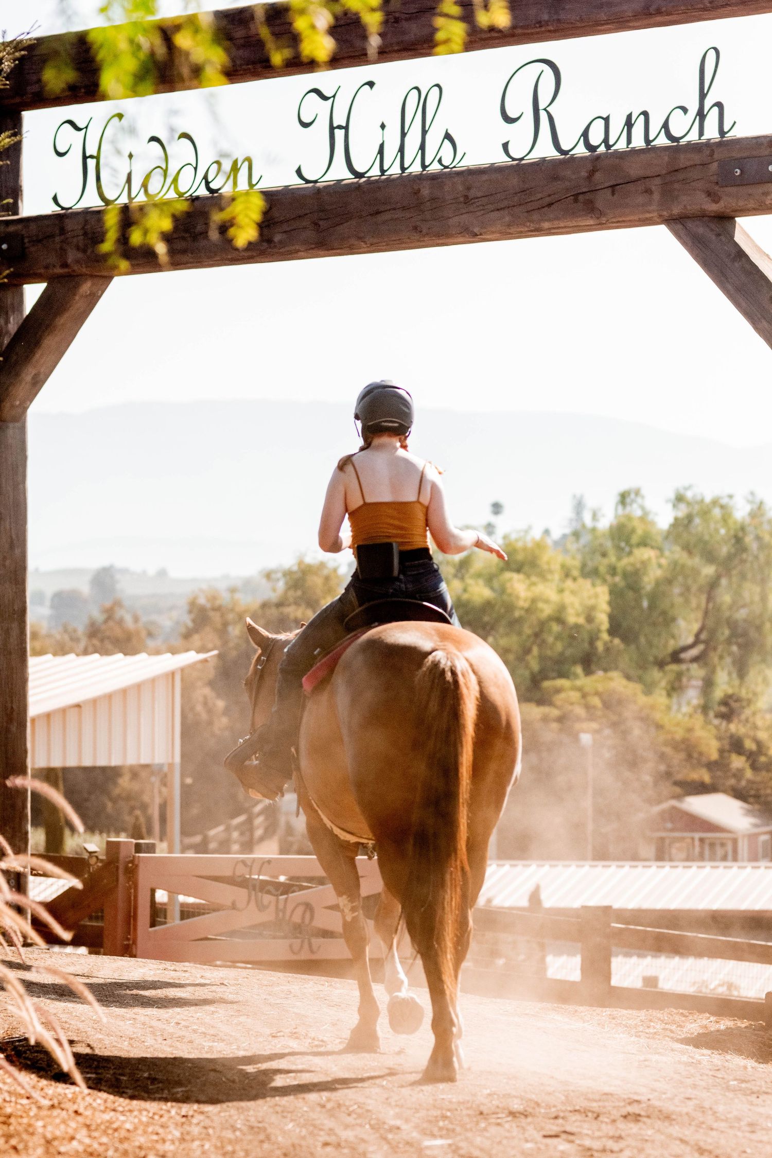Girl rides horse at Hidden Hills Ranch in Bonsall, California