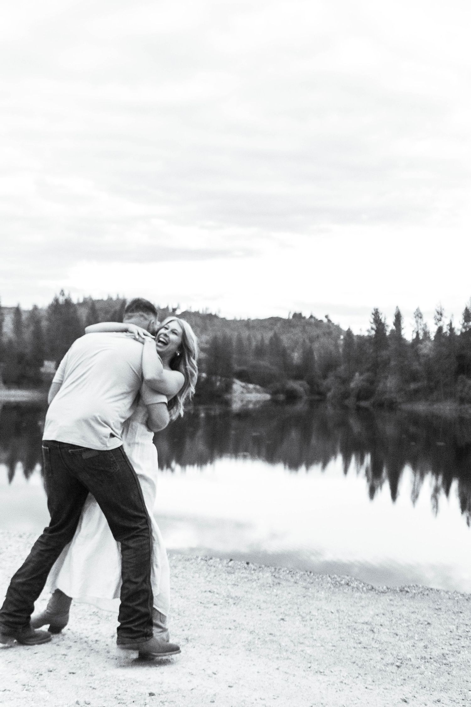 man and woman hugging by lake in Pine Grove, California