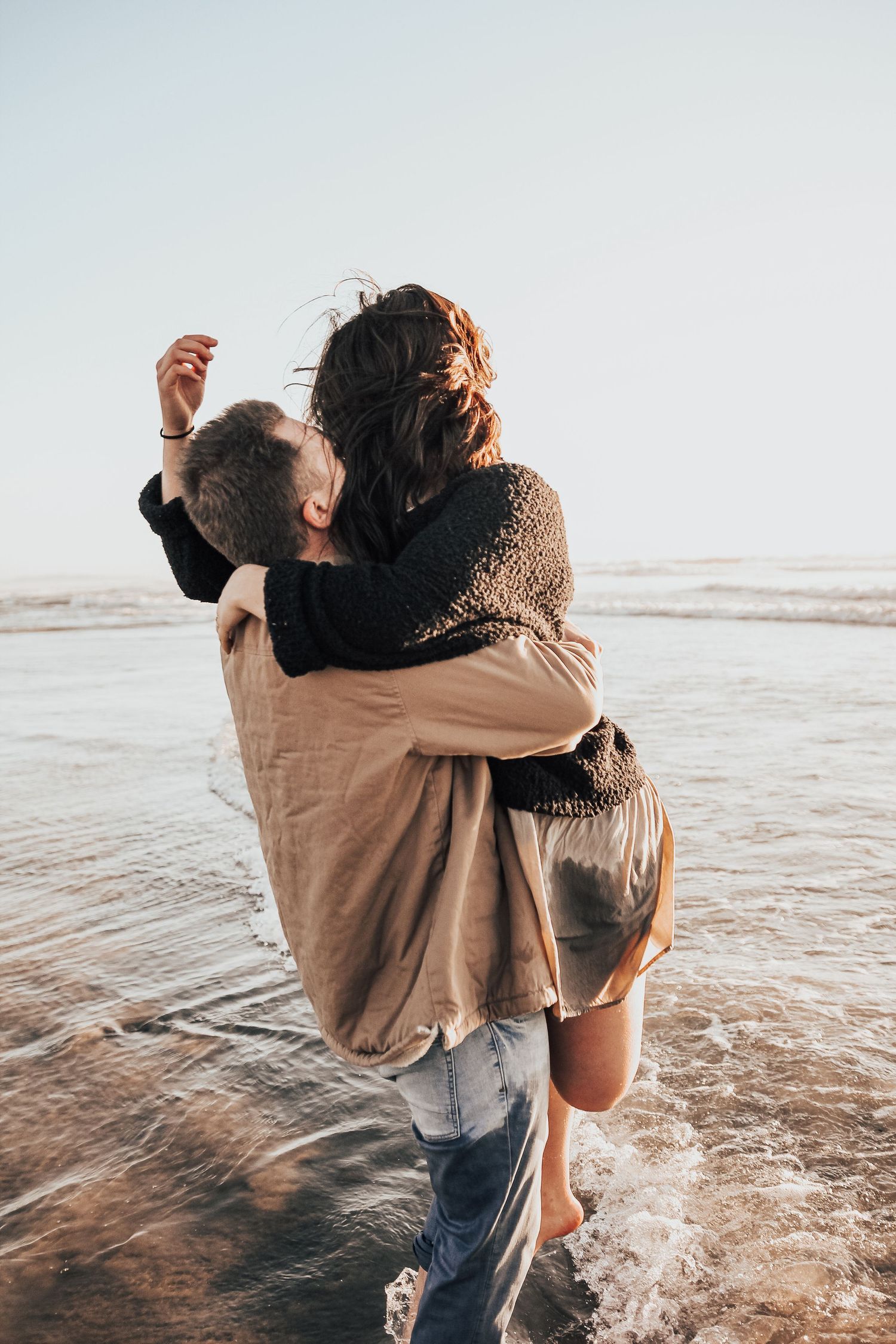 couple hugging in ocean in Encinitas, California
