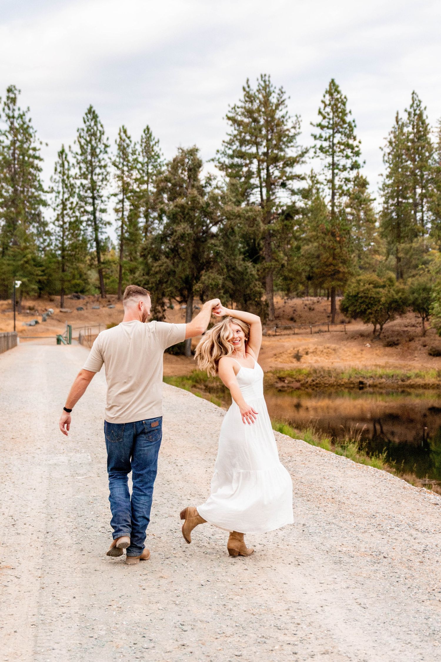 man and woman dancing by lake in Pine Grove, California