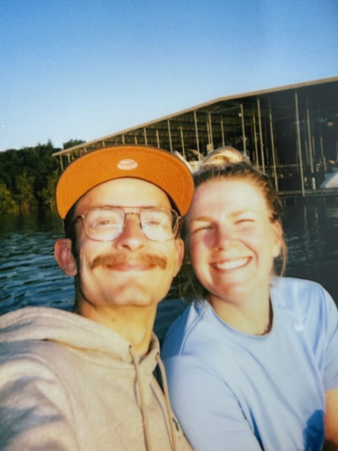 man and woman on boat in lake