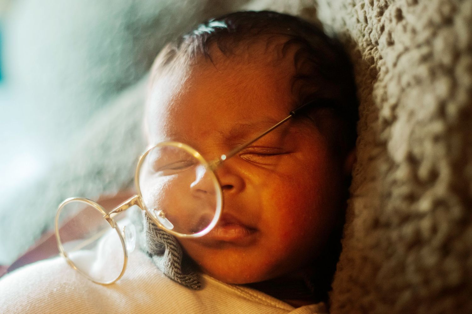 Close-up sequence of a sleeping Newborn with glasses in soft lighting. Newborn Photoshoot Pawtucket, Rhode Island