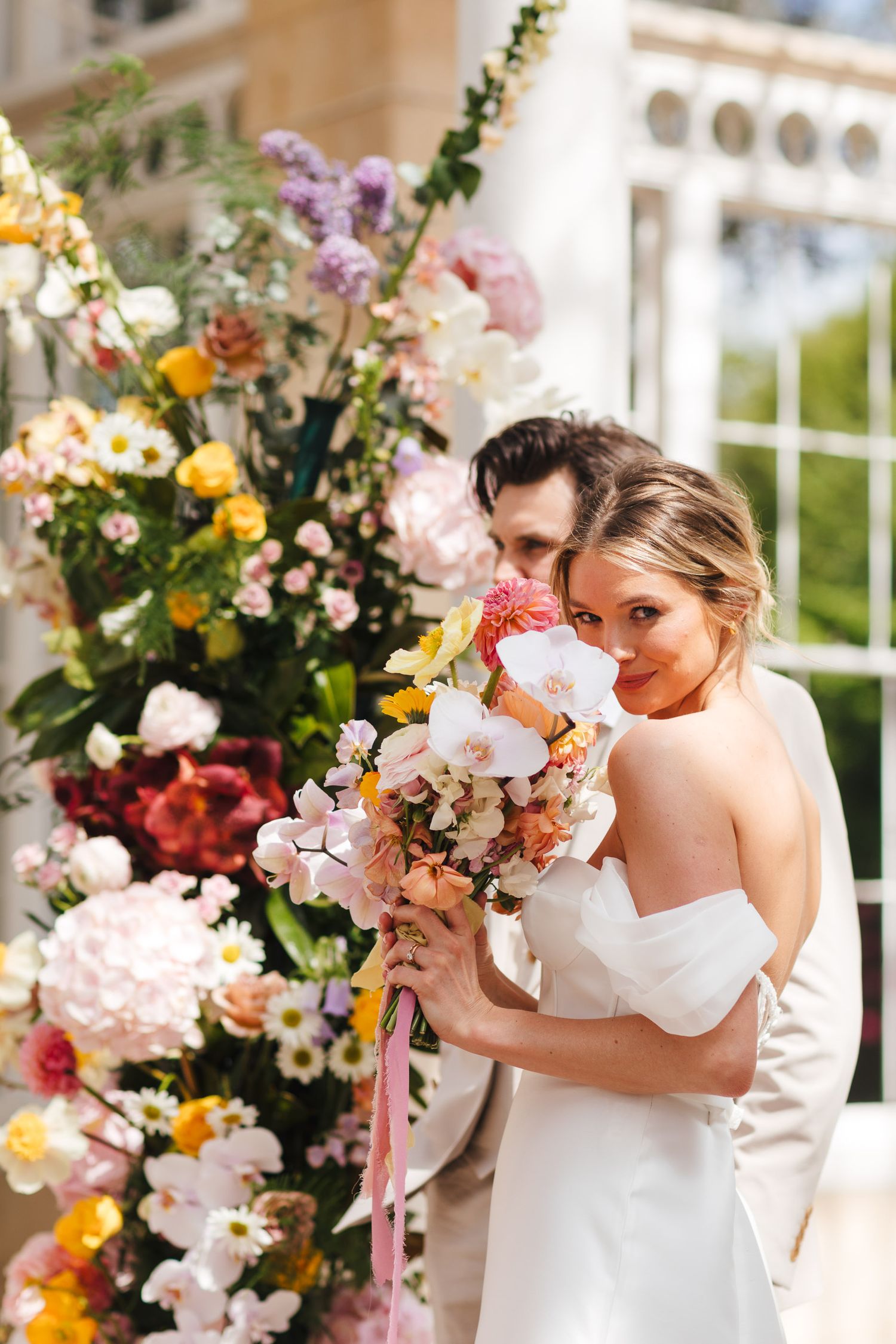 Bride portrait at Syon Park London, elegant spring wedding photography with vibrant floral installation