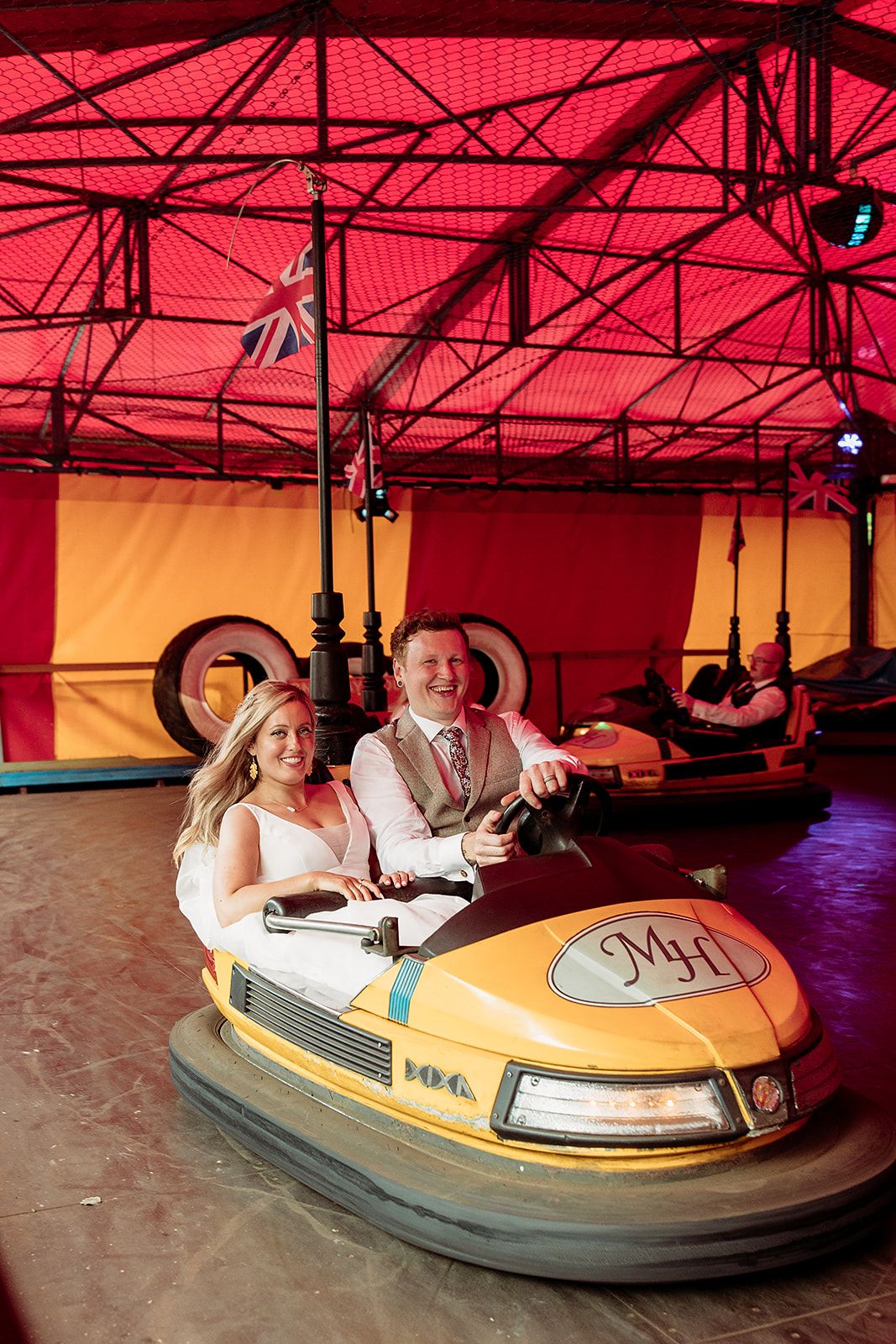 Bride and groom on fairground ride at Marleybrook House Kent, fun wedding moment from photographer’s own day