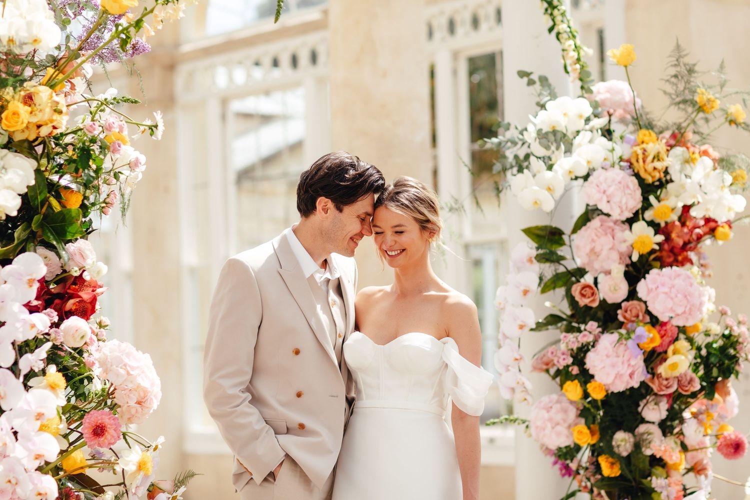 Luxury wedding couple portrait at Syon Park London, romantic spring ceremony styling and floral backdrop