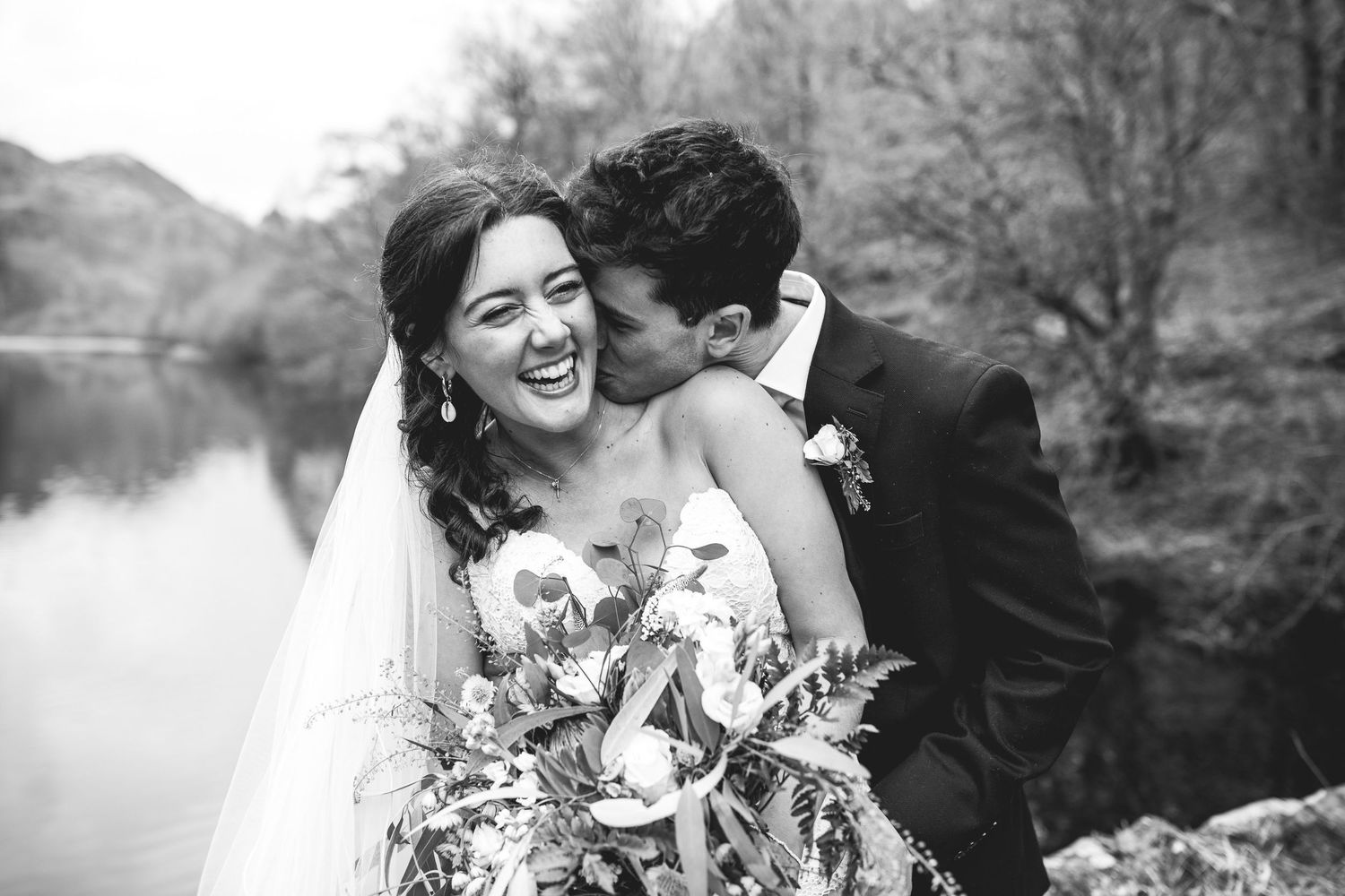 Romantic Lake District elopement portrait by lakeside, candid black and white wedding photography