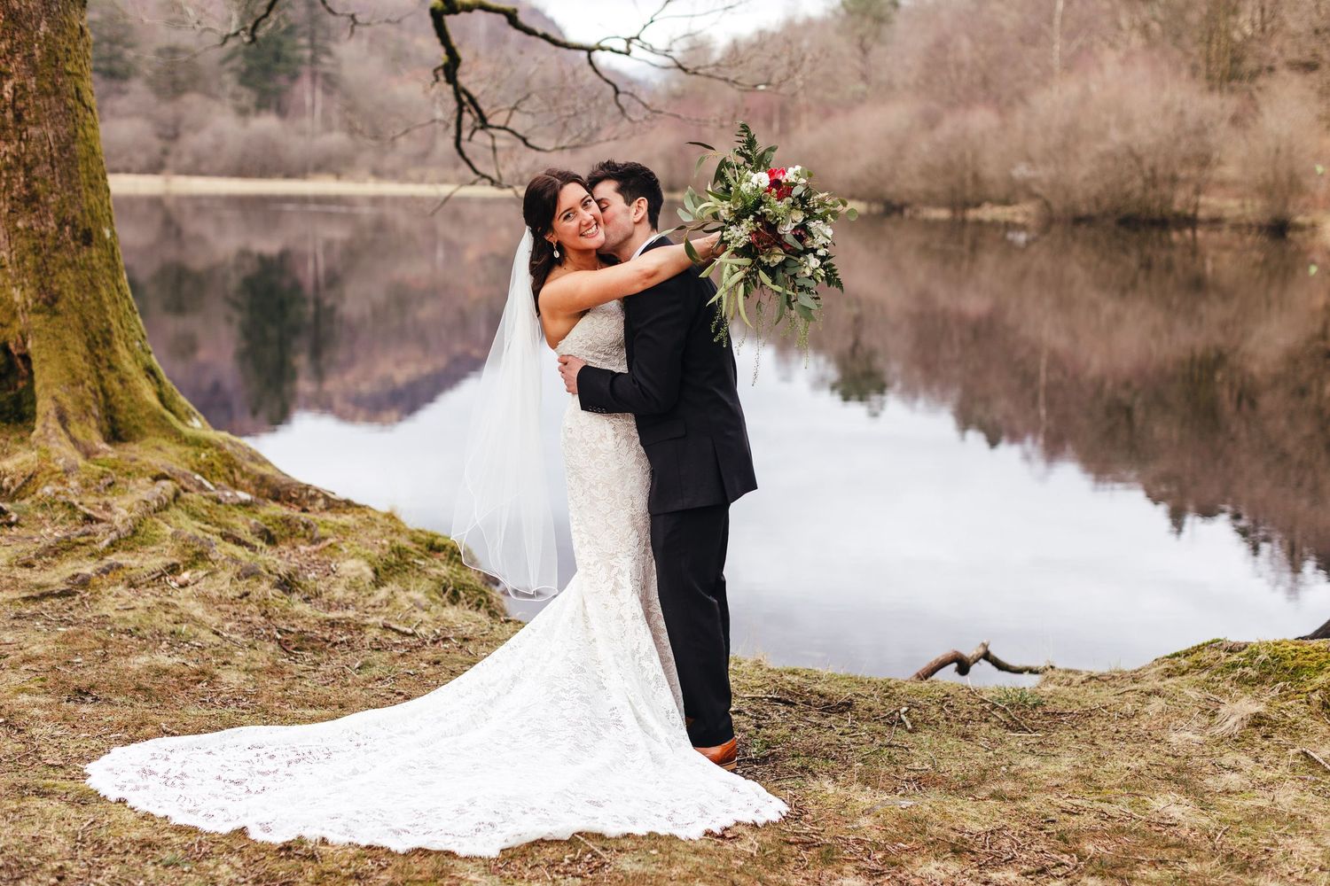 Lake District wedding couple embracing by lakeside, captured by Derbyshire wedding photographer Mimi Foster
