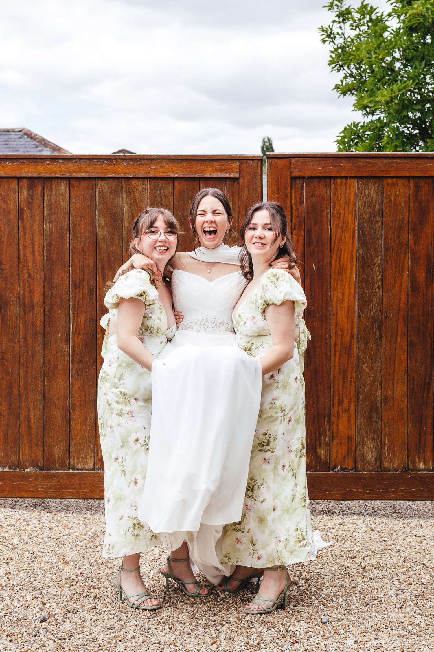 Bride with bridesmaids at Kimbridge Barn wedding venue in Romsey