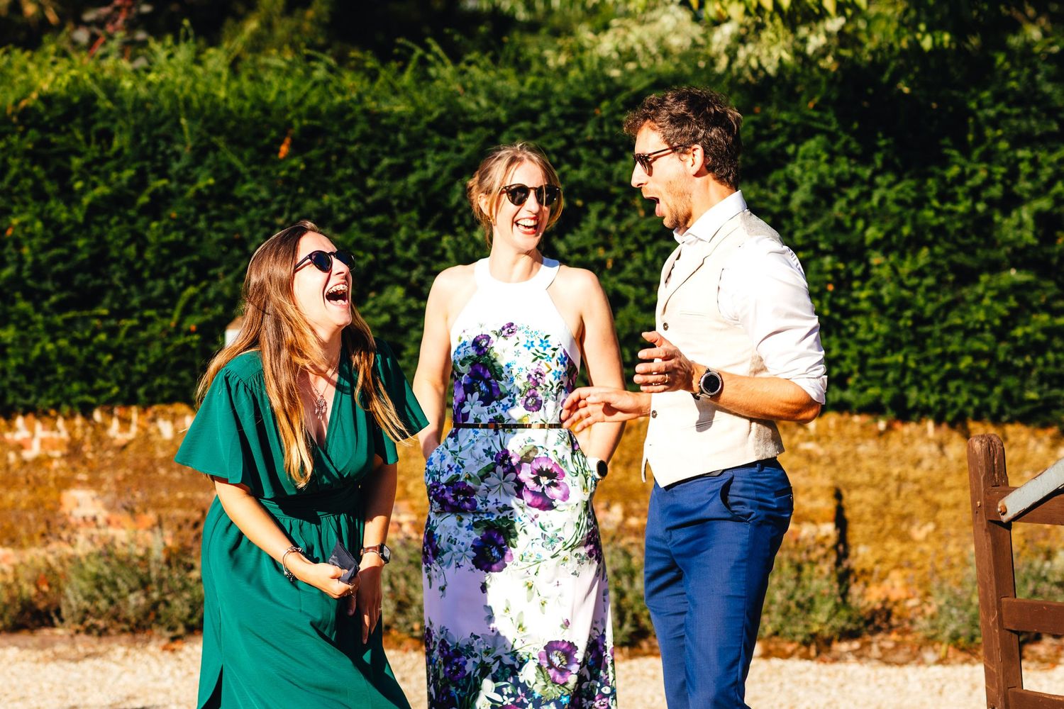 Guests laughing outdoors at Kimbridge Barn wedding reception in Romsey