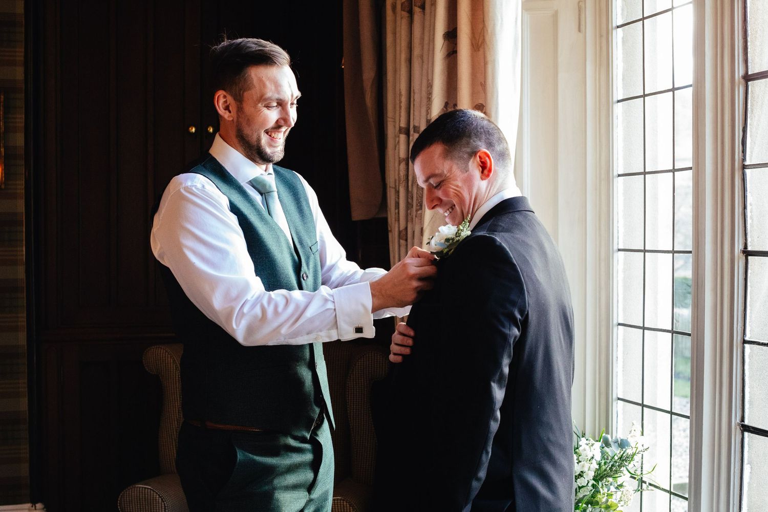Groom helping with jacket at Falcon Manor Settle, elegant spring wedding at North Yorkshire country house venue
