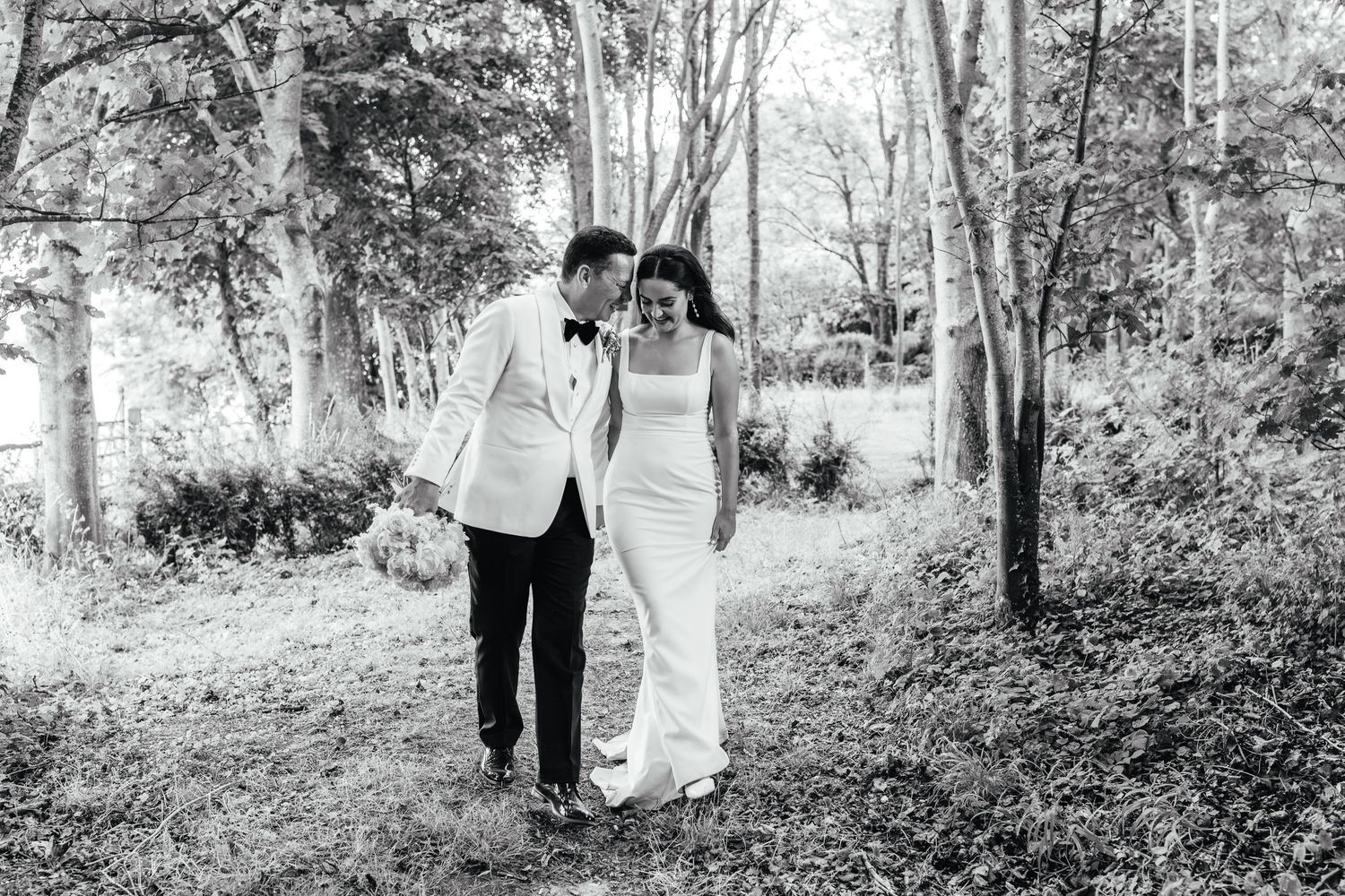 Black and white candid couple portrait at Cissbury Barns Worthing, captured by Derbyshire wedding photographer Mimi Foster