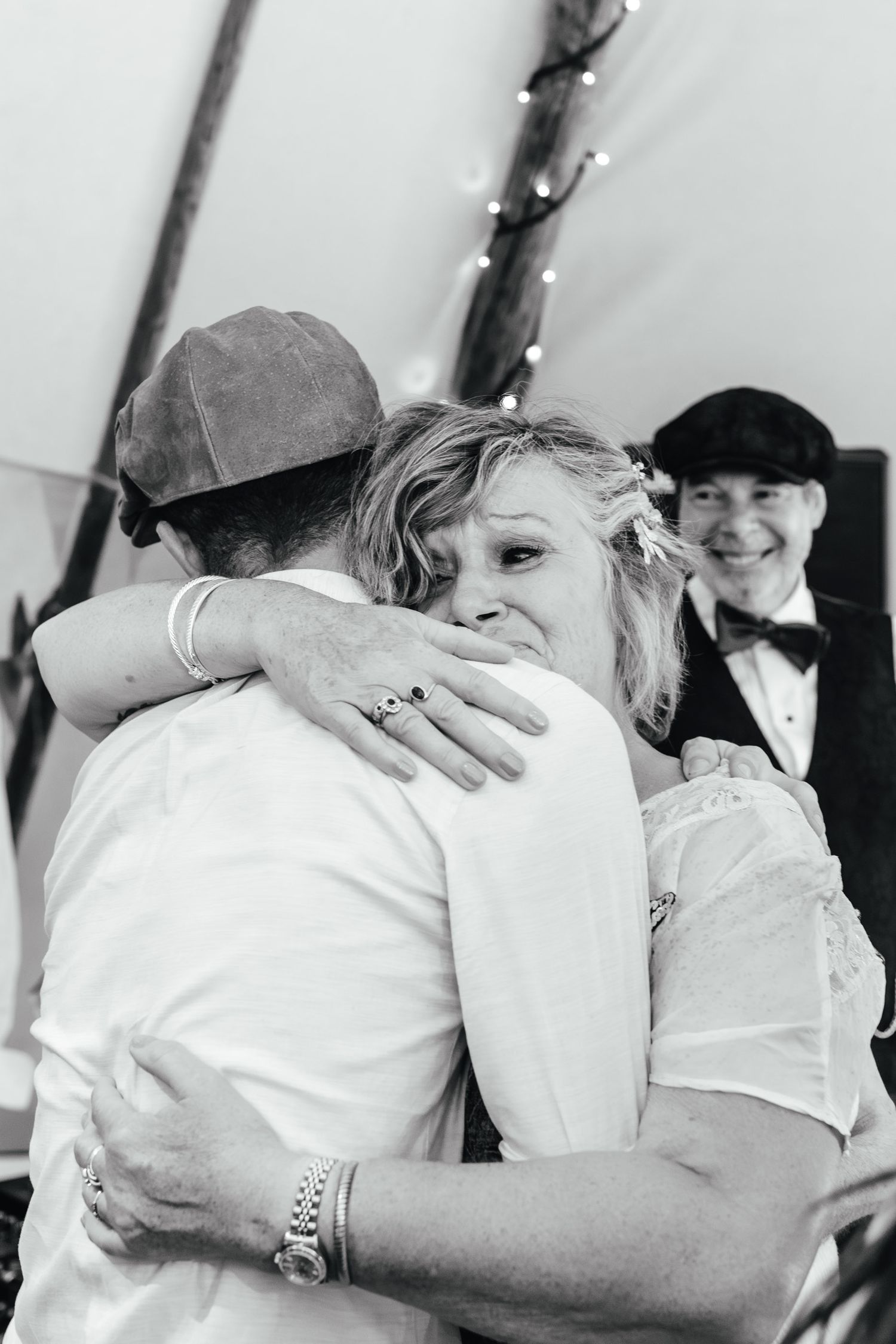 Emotional hug during Derbyshire wedding reception, black and white documentary wedding photography