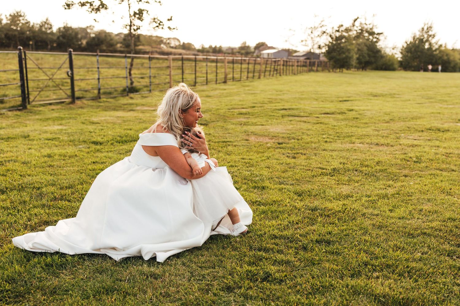 Bride sitting in meadow at Peak Edge Hotel wedding, Derbyshire countryside photography