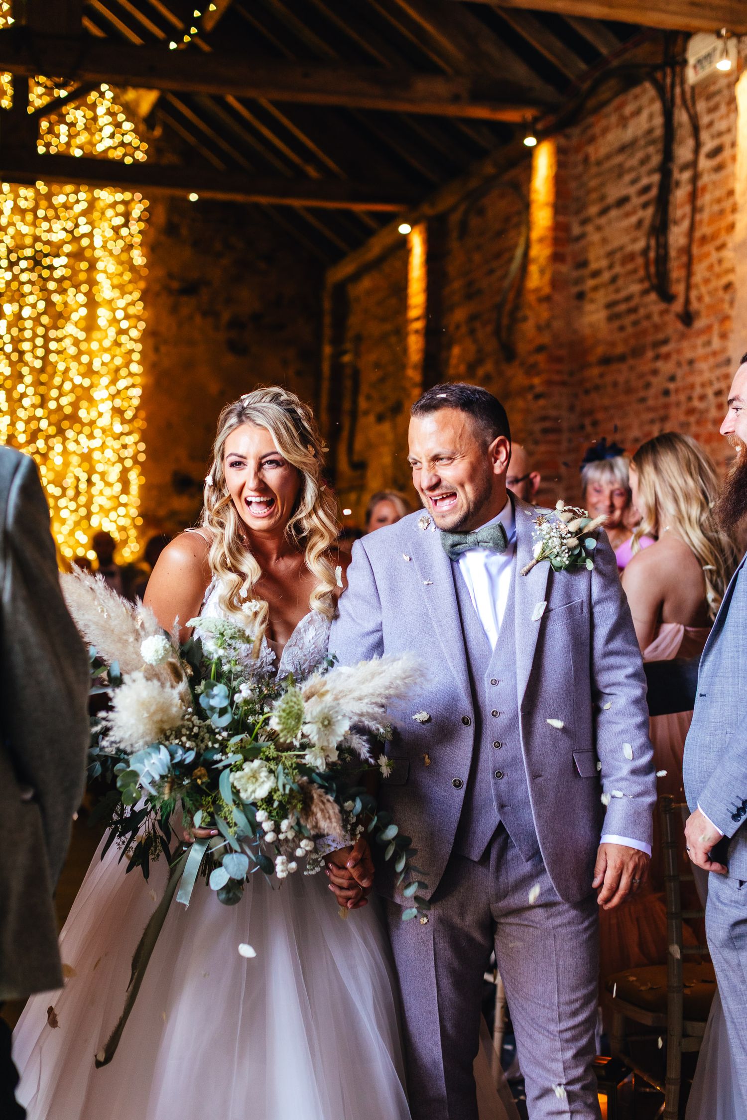 The Normans York wedding photography, joyful summer confetti moment inside luxury North Yorkshire barn venue