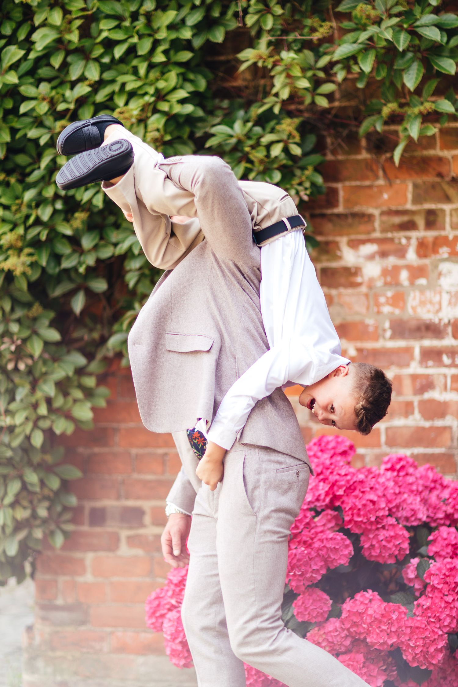 The Normans York barn wedding, fun romantic couple portrait against brick wall, modern North Yorkshire wedding photography