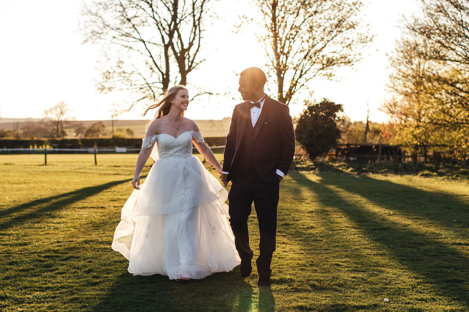 Bride and groom walking at sunset in Oxfordshire, relaxed documentary wedding photography