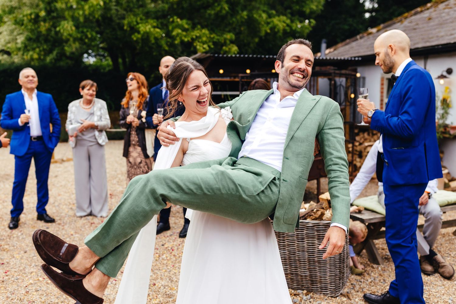 Fun summer barn wedding at Kimbridge Barn with candid celebration moment, relaxed UK wedding photography