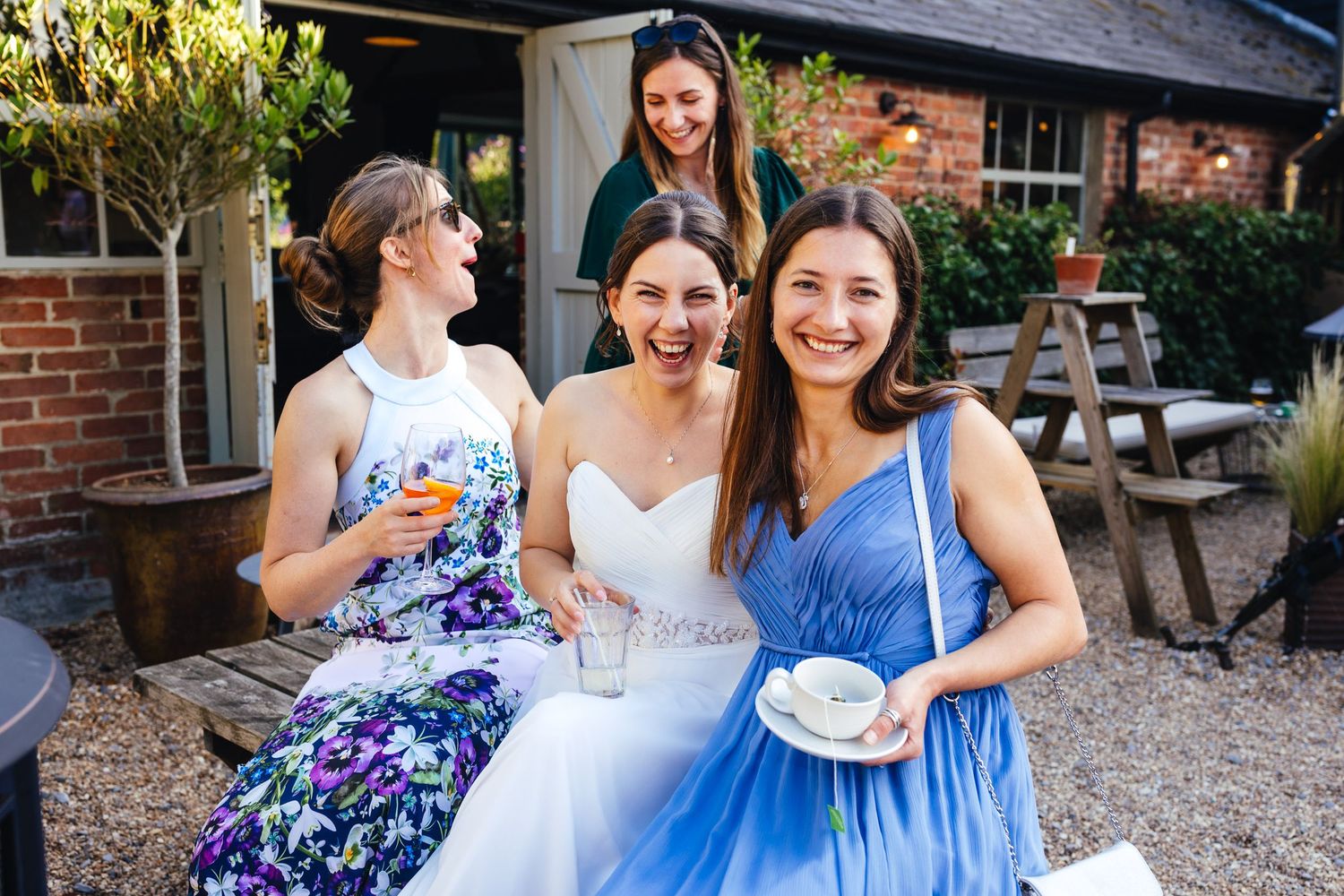 Bride with friends at Kimbridge Barn wedding reception in Romsey