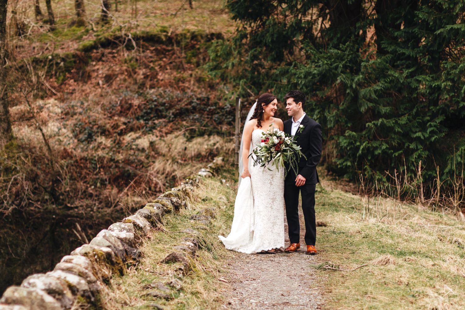 Lake District wedding couple portrait on woodland path, natural documentary outdoor wedding photography