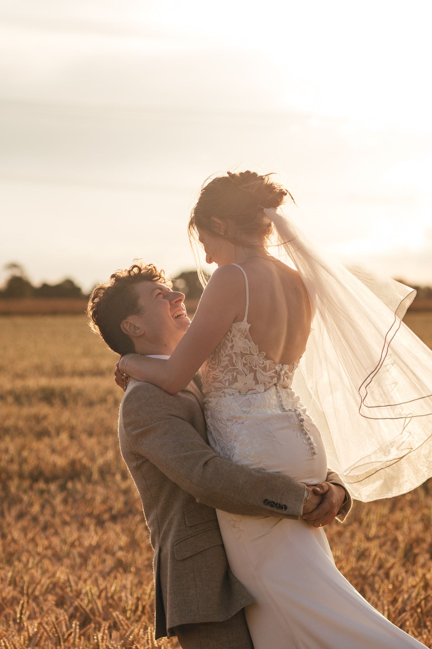 Derbyshire sunset wedding portrait in golden fields, captured by Derbyshire wedding photographer Mimi Foster