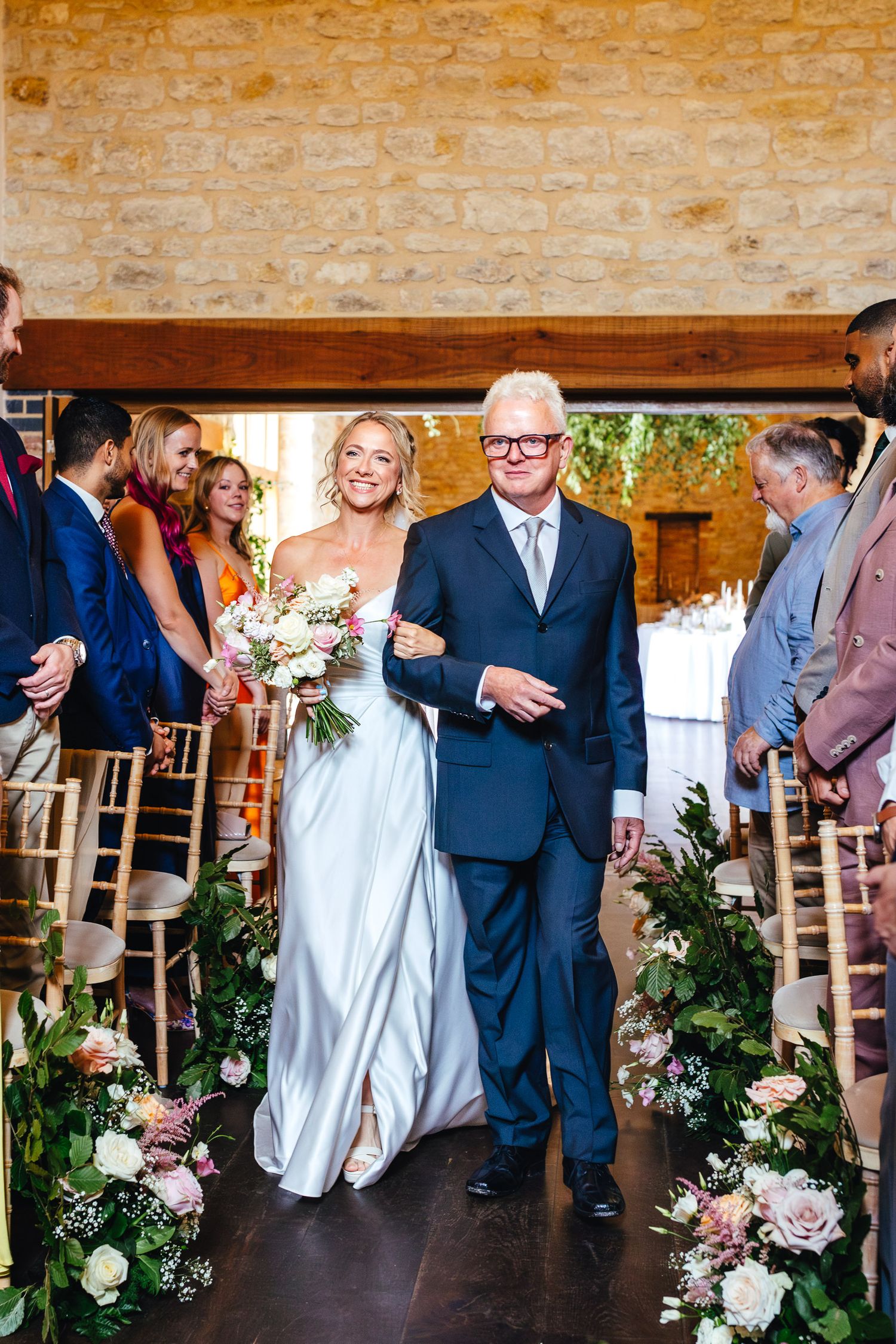 Bride and father walking down aisle at Huntsmill Farm Buckinghamshire, natural barn wedding photography