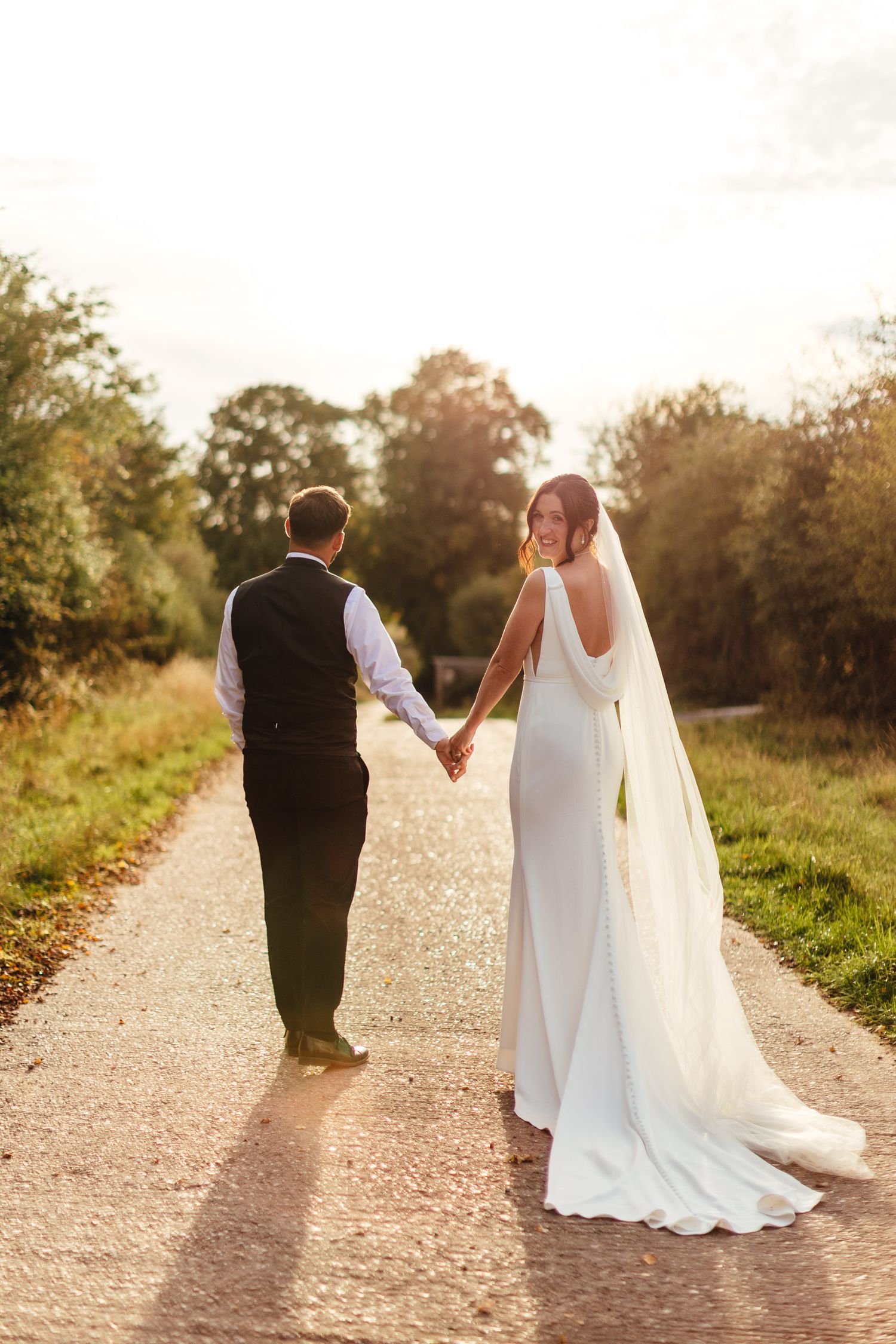 Golden hour wedding couple walking at Inkersall Grange Farm Newark, East Midlands countryside wedding photography