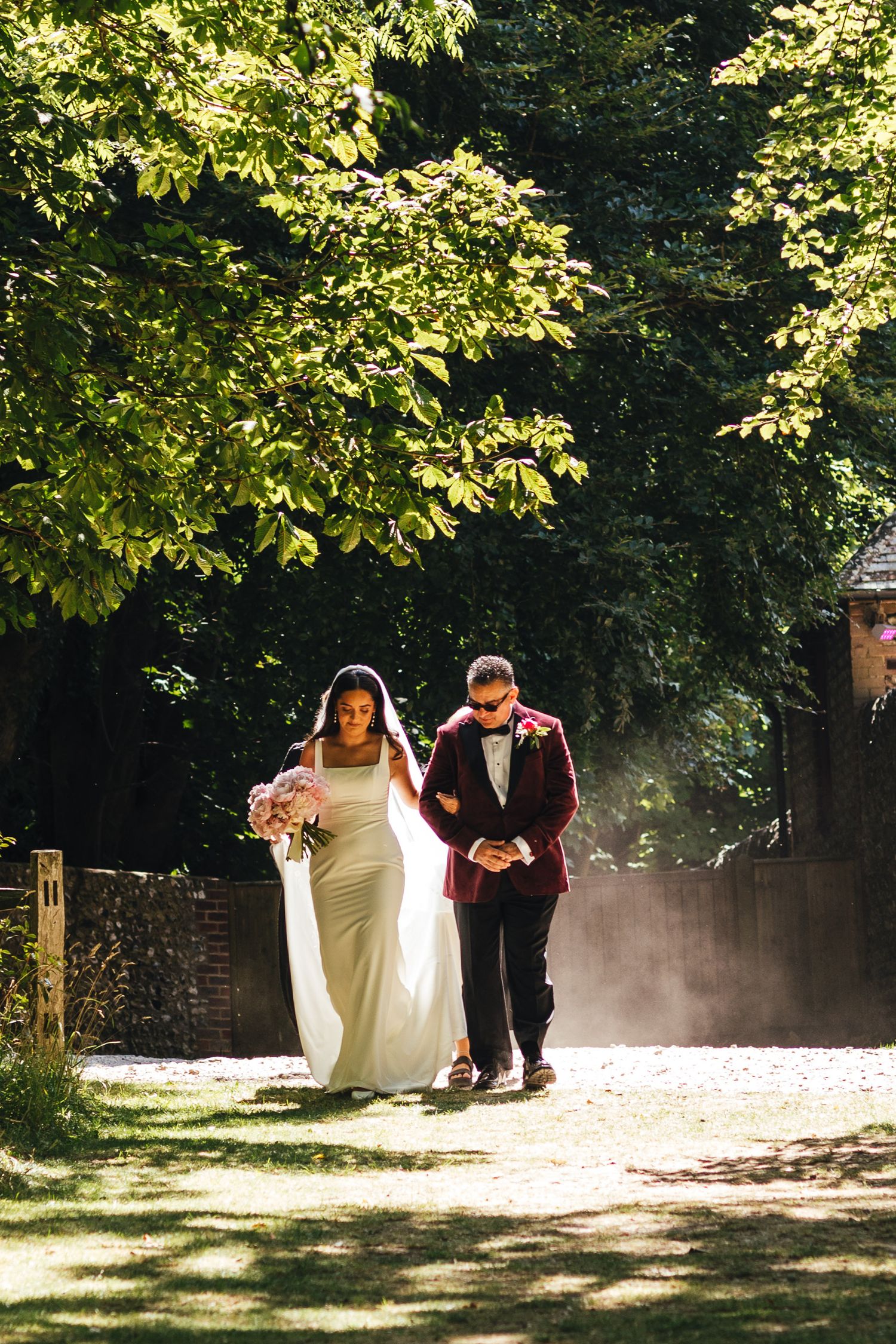 Bride and father walking at Cissbury Barns Worthing, natural wedding photography