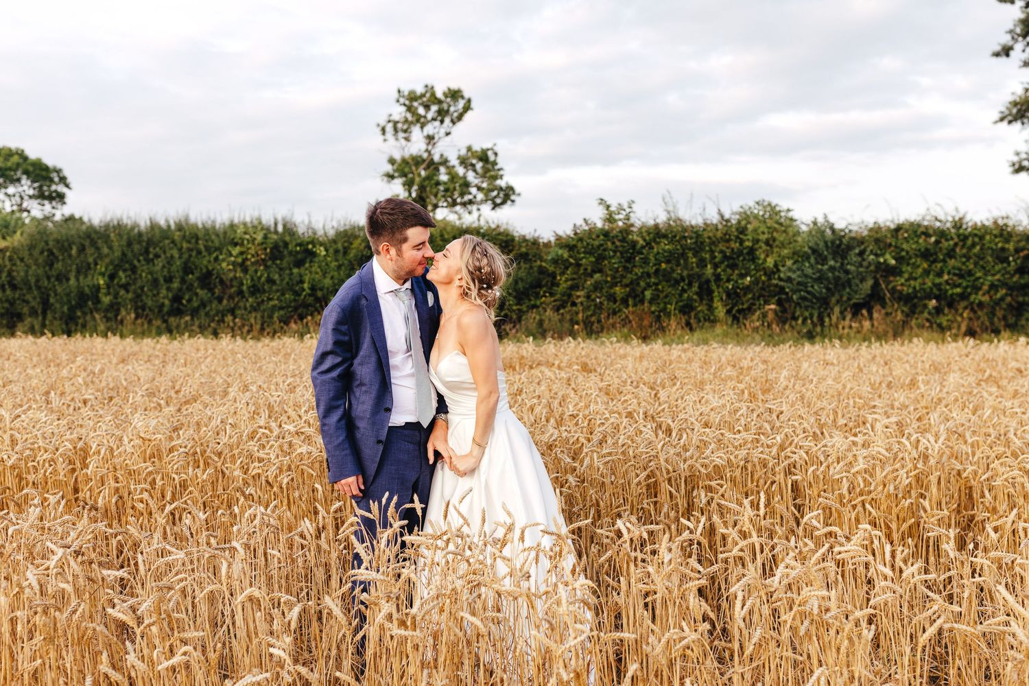 Golden hour couple portrait in wheat field at Huntsmill Farm Buckinghamshire