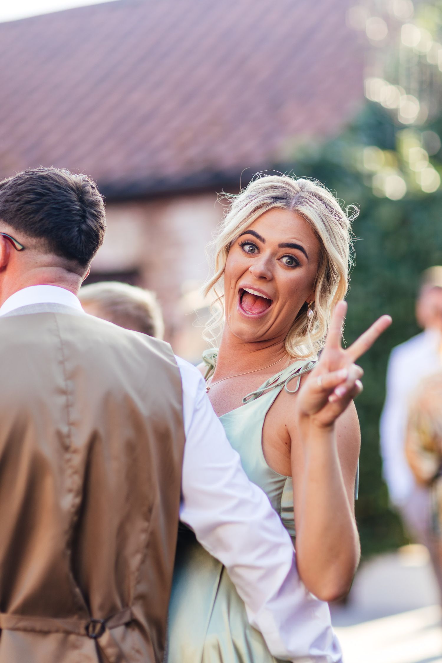 The Normans York barn wedding, fun candid bridesmaid moment during summer reception in North Yorkshire