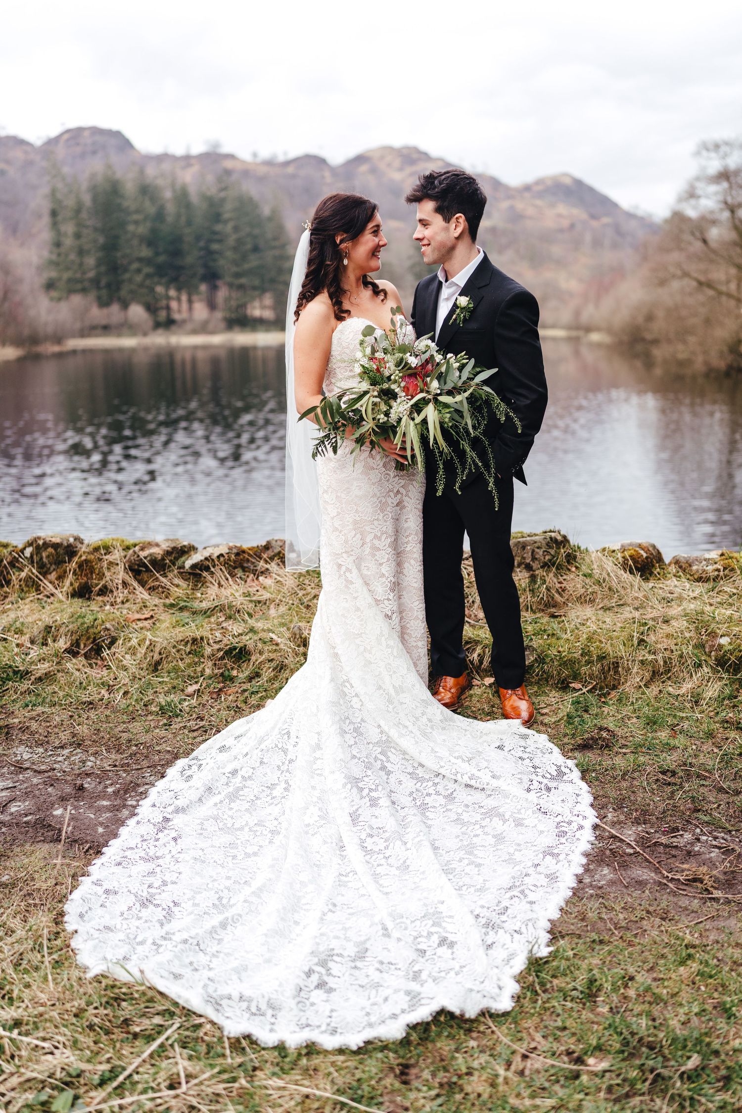 Bride and groom portrait by lakeside in the Lake District, natural documentary UK wedding photography